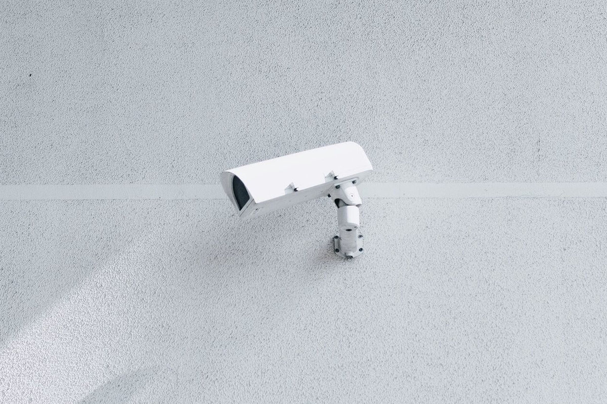 white security camera on white wall